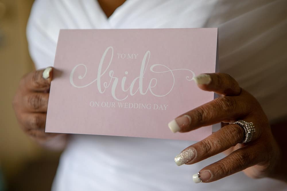 Picture of the bride holding a special card from her husband to be 