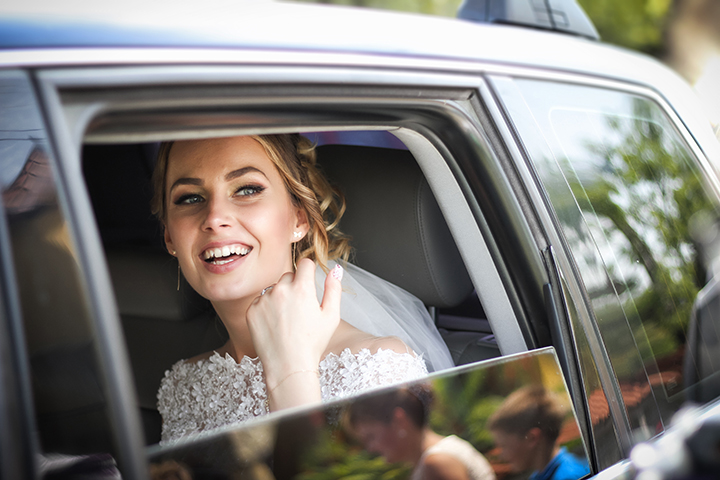 Bride in car after wedding